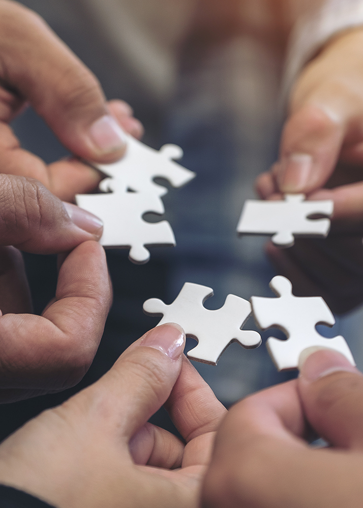 diverse-hands-holding-jigsaw-puzzle-pieces-to-connect-with-cultural-intelligence